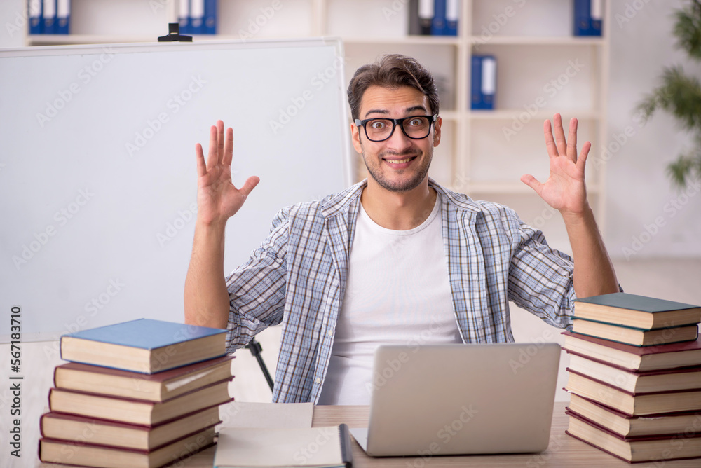 Young male student preparing for exams in the classroom Young male student preparing for exams in the classroom