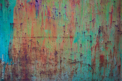 multicolored rusty and weathered metal surface with shades of turquoise blue  orange  green  red and yellow colors - texture of a fence for the background of a steampunk wallpaper