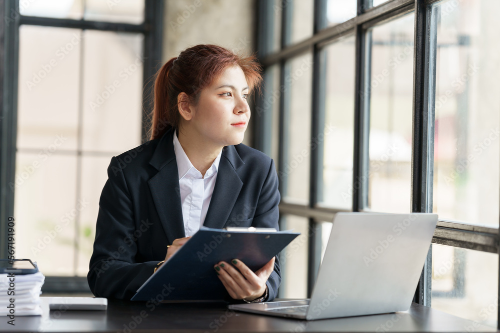Young pretty asia people business woman working with audit, balance sheet, stock market statistics and online meeting in video conference. Young pretty asia people business woman working with audit, balance sheet, stock market statistics and online meeting in video conference.