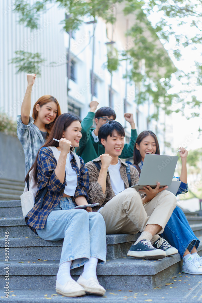 Attractive asian college student using laptop and tablet studying with group of friends together with english language classroom, social media and education concept.