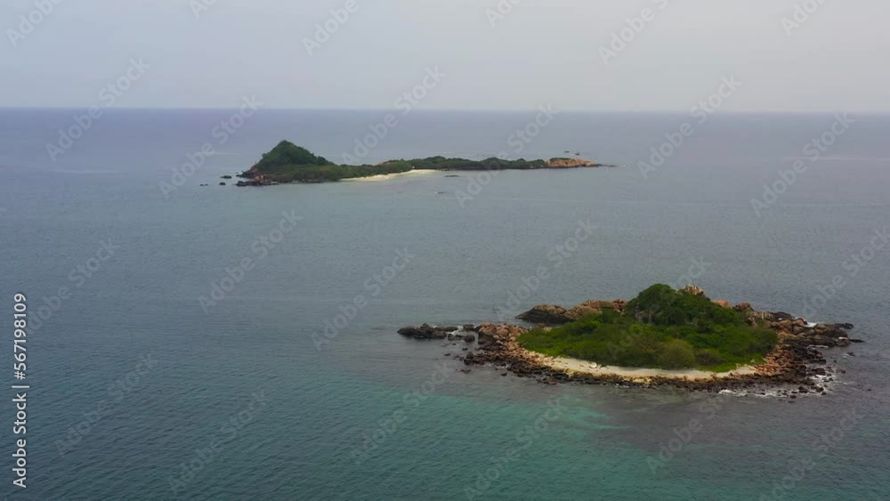 Seascape with tropical islands and a sandy beach in the sea.. Pigeon Island, Sri Lanka. Seascape with tropical islands and a sandy beach in the sea.. Pigeon Island, Sri Lanka.