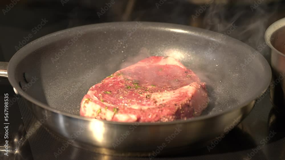 Cooked and grilled steak on pan with a little tomato with it, and take a break on a wicker plate for the next step. Cooked and grilled steak on pan with a little tomato with it, and take a break on a wicker plate for the next step.