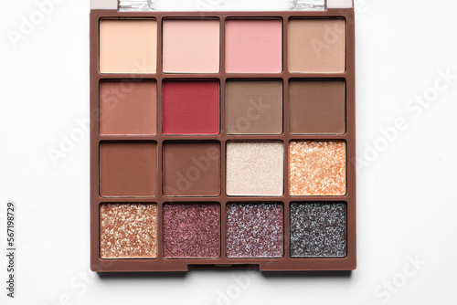 Beautiful eye shadow palette on white table  top view