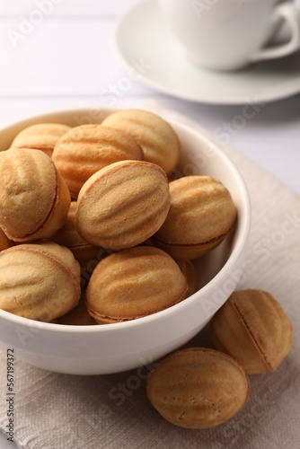 Delicious nut shaped cookies with boiled condensed milk on white wooden table