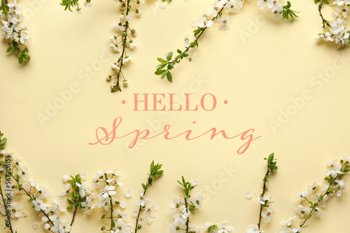 Beautiful blooming branches and text HELLO, SPRING on beige background