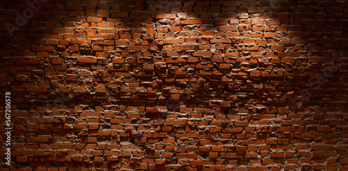 Red brick wall with lights shining from above Suitable for making background images of infographics.