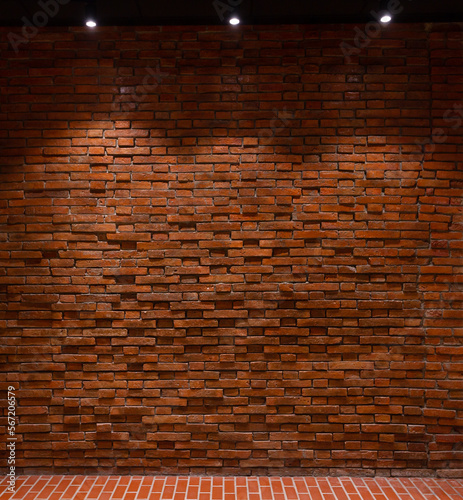 Red brick wall with lights shining from above Suitable for making background images of infographics.