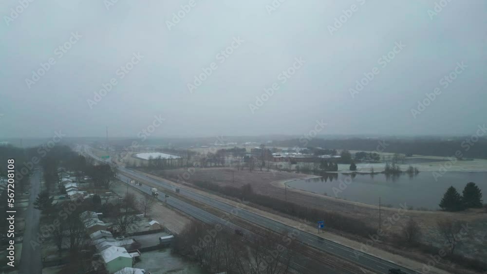 Flying Over Main Road Near Beautiful Lake In Snowy Weather In Warren, Ohio, USA Flying Over Main Road Near Beautiful Lake In Snowy Weather In Warren, Ohio, USA