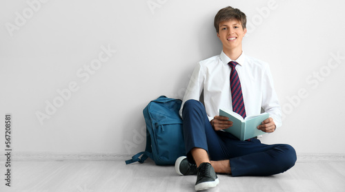 Teenage boy with book and b...