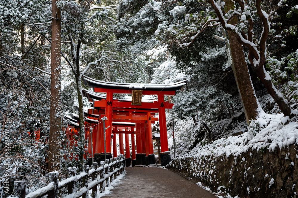 Fototapeta premium Kyoto, Japan. Fushimi Inari-taisha Torii Gates with snow on the roof in winter.