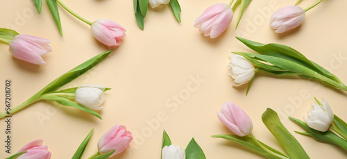 Fototapeta Naklejka Na Ścianę i Meble -  Frame made of beautiful tulip flowers on beige background. Hello spring