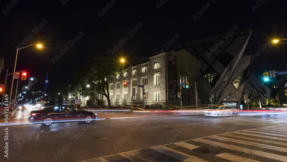 Timelapse of traffic at night at a busy intersection next to the Royal Ontario Museum with the iconic CN Tower lit up in the distance in Toronto Timelapse of traffic at night at a busy intersection next to the Royal Ontario Museum with the iconic CN Tower lit up in the distance in Toronto