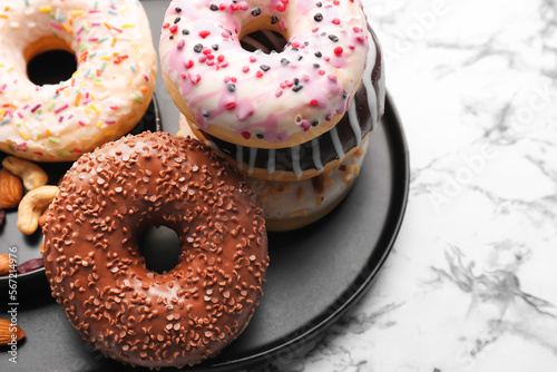 Plate with sweet donuts on ...
