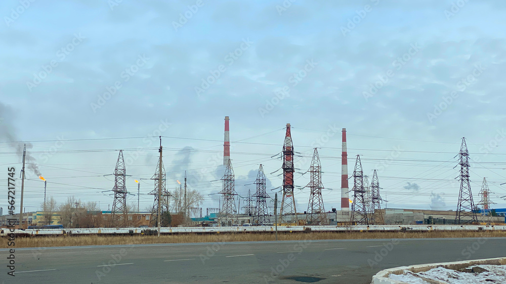 Gas processing plant. View of gas flares and striped pipes of a thermal power plant. Air pollution and ecology. 