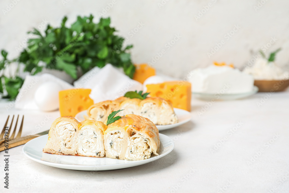 Plate with piece of delicious cheese pie and parsley leaf on white table Plate with piece of delicious cheese pie and parsley leaf on white table
