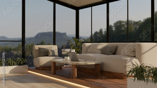 Luxury contemporary living room with couch, coffee table, and glass wall with nature view © bongkarn