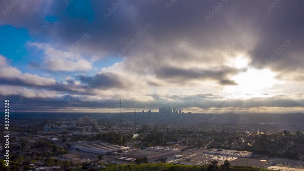 Drone hyperlapse during sunset over a Los Angeles suburb with downtown skyline silhouette in the distance Drone hyperlapse during sunset over a Los Angeles suburb with downtown skyline silhouette in the distance