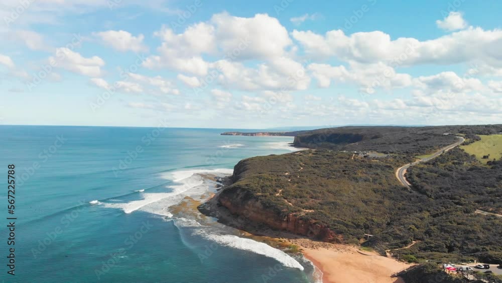 Aerial view of coastal landscape of Torquay Bells Beach surrounded by lush green hills that rise up from the shoreline Aerial view of coastal landscape of Torquay Bells Beach surrounded by lush green hills that rise up from the shoreline