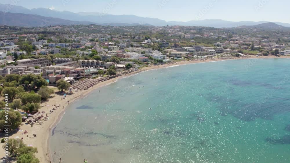 Panoramic View Of A Crystal Clear Beach In Tropical Resort Of Chania Town, Crete Island, Greece. Aerial Drone Shot Panoramic View Of A Crystal Clear Beach In Tropical Resort Of Chania Town, Crete Island, Greece. Aerial Drone Shot