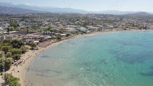 Panoramic View Of A Crystal Clear Beach In Tropical Resort Of Chania Town, Crete Island, Greece. Aerial Drone Shot photo