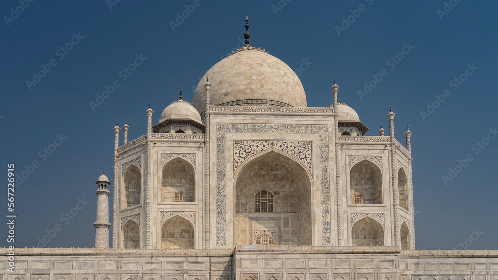 The beautiful ancient mausoleum of the Taj Mahal against the blue sky