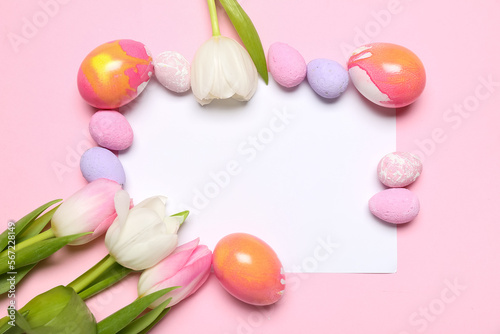 Composition with blank card  painted Easter eggs and tulip flowers on pink background