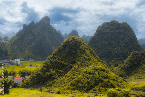 Triangular shaped mountains of the northern Vietnam and southern Guangxi, China. Limestone rocks, dramatic sky, copy space for text