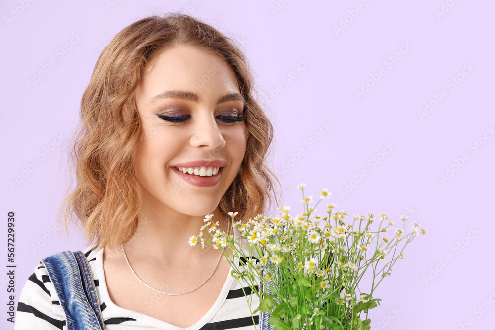 Beautiful happy young woman with bouquet of chamomiles on lilac background Beautiful happy young woman with bouquet of chamomiles on lilac background