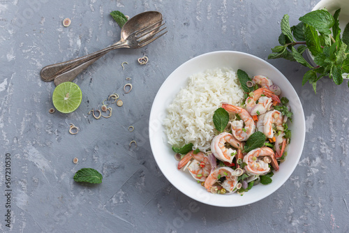 Healthy food shrimp salad has peppermint lemon grass kale has rice in bowl on grey wood background. photo