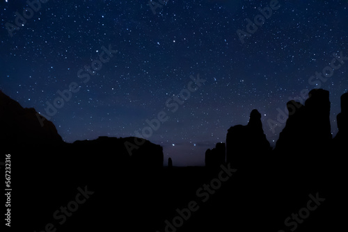 The night sky over the desert rock formations of Utah in Arches National Park.