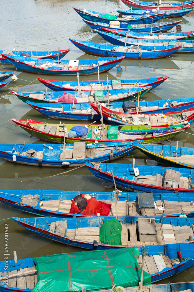 Elevated view over blue fishing boats lined up at Lang Co in Vietnam