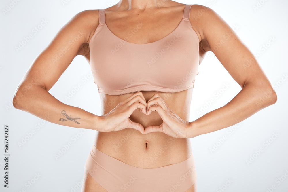 Fitness, heart shape and woman body in a studio for self love, motivation and positivity. Diet, health and slim female model with a love hand sign for weightloss and wellness by a gray background. Fitness, heart shape and woman body in a studio for self love, motivation and positivity. Diet, health and slim female model with a love hand sign for weightloss and wellness by a gray background.