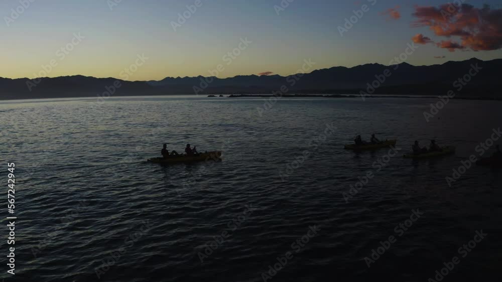 Kayaking in the ocean at Kiakoura New Zealand during a beautiful sunrise with friends Kayaking in the ocean at Kiakoura New Zealand during a beautiful sunrise with friends