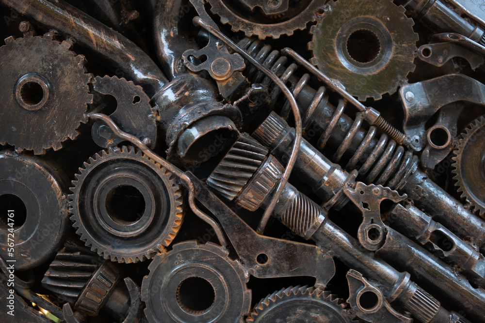 texture metal junk nuts bolts wires and other spare parts piled in a mix of metal debris with gears and rust abstract image