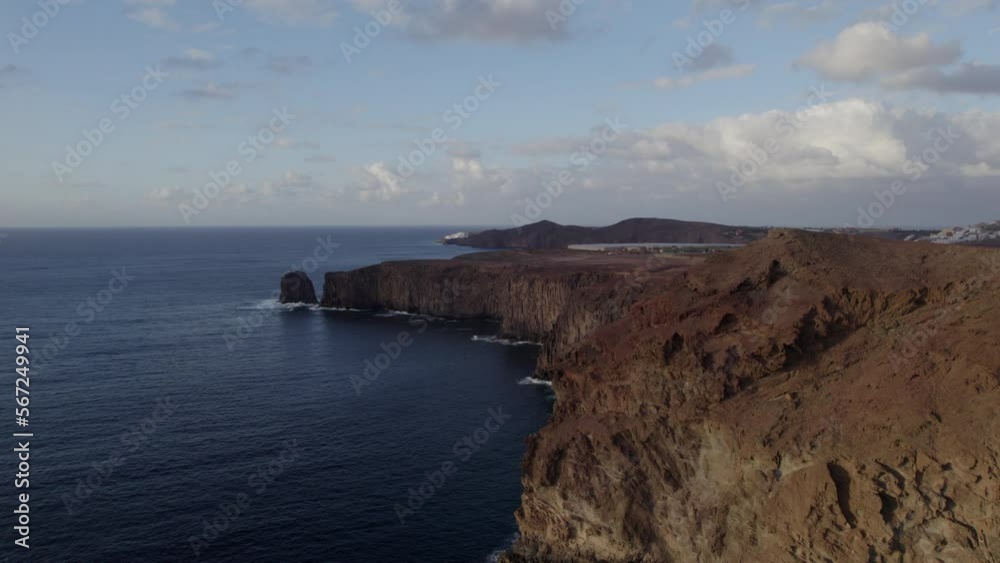 Fantastic aerial shot approaching the coast and cliffs during sunset and where you can see the Partido cliff on the island of Gran Canaria. Fantastic aerial shot approaching the coast and cliffs during sunset and where you can see the Partido cliff on the island of Gran Canaria.