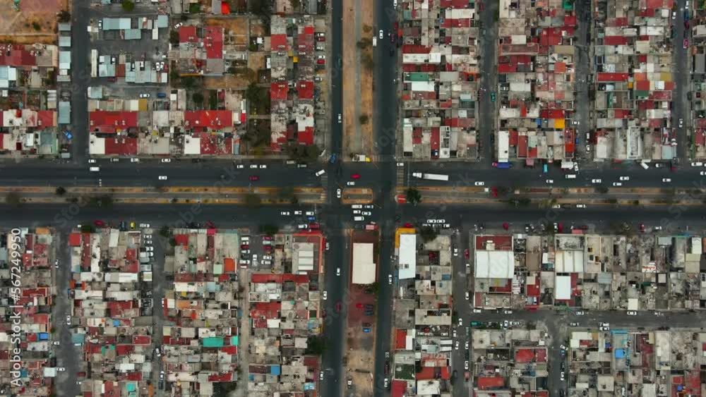 Top down aerial view from drone on suburban traffic junction of multiple lane road in metropolis city. Aerial view of crossroad in Mexico City suburbs.