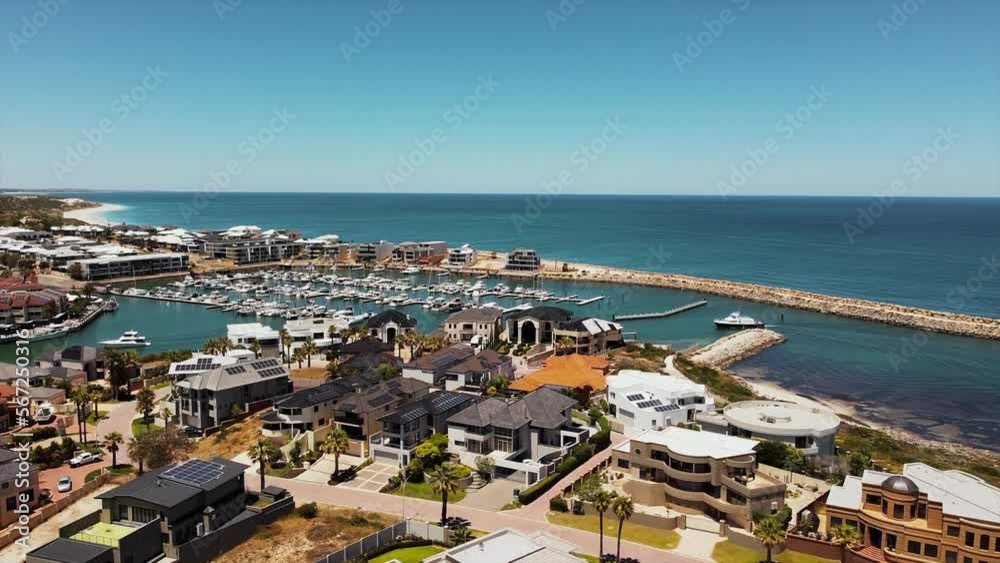 Drone panorama of luxurious marina bay resort and townhouses with private harbor and yachts and boats anchored. Aerial view of luxury waterfront neighborhood Drone panorama of luxurious marina bay resort and townhouses with private harbor and yachts and boats anchored. Aerial view of luxury waterfront neighborhood