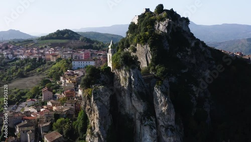 Left orbiting reveal shot of Bagnoli del Trigno town with San Silvestro church between two rock spurs, Isernia and Molise region, Italy, 4K photo