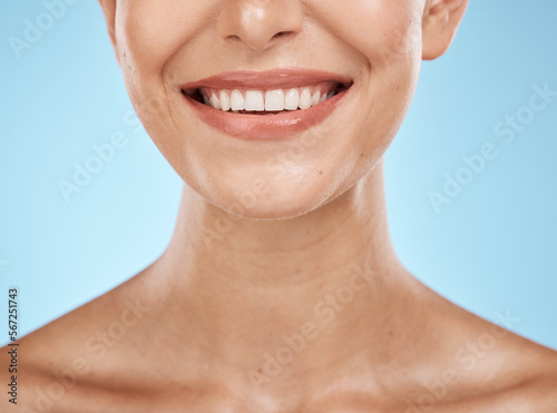 Closeup, mouth and woman with skincare, cosmetics and dermatology with girl on blue studio background. Face, female and lady with clean teeth, natural beauty and grooming routine for fresh breath