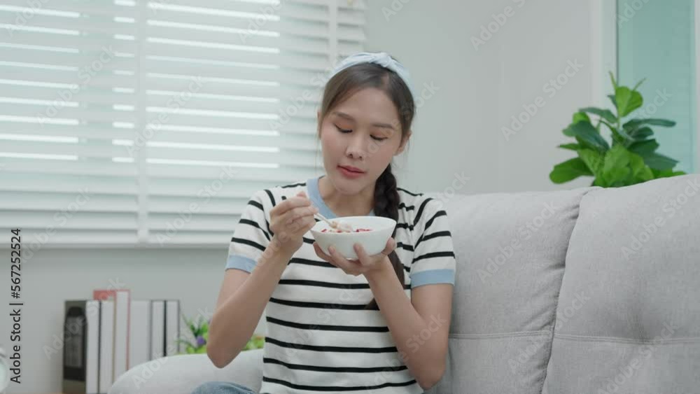 Beautiful girl enjoy eat yogurt on breakfast health in house. Happy young woman smile on morning for good emotion. female Clean eat, dieting, detox, yogurt diet. Diet Happy and Healthy food concept Beautiful girl enjoy eat yogurt on breakfast health in house. Happy young woman smile on morning for good emotion. female Clean eat, dieting, detox, yogurt diet. Diet Happy and Healthy food concept
