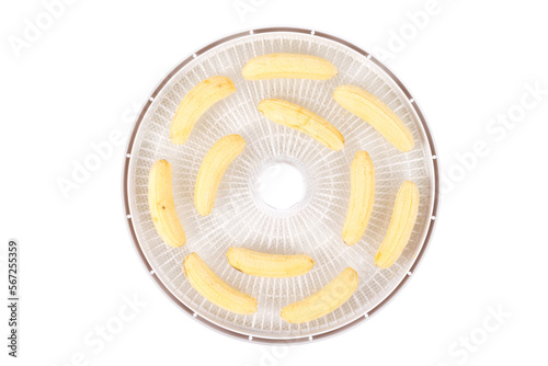 on a white round grate, peeled bananas..for further drying