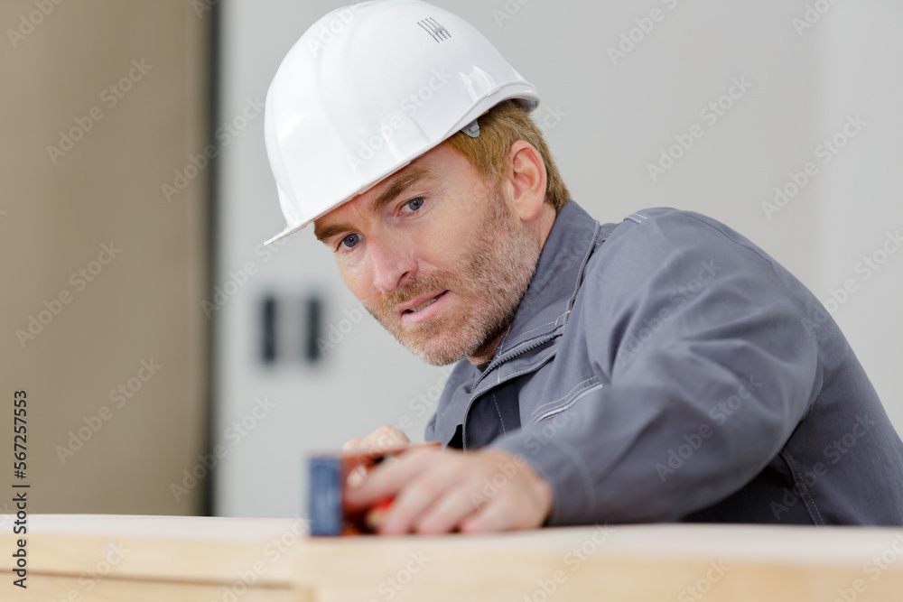 senior carpenter using spirit level senior carpenter using spirit level
