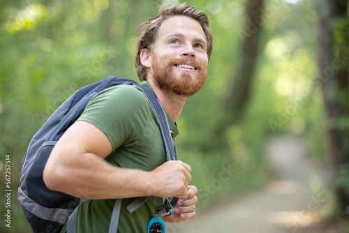 attractive hiker with big traveling rucksack moving up
