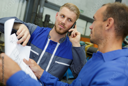 two engineers are discussing plans