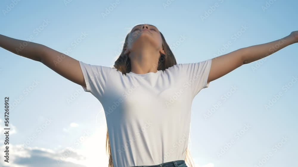 Happy girl with raised arms above her head. Celebrating achievement goal, victory of dream. Emotions of girl with raised hands of delight. emotion of happiness is dream to victory. Happy girl with raised arms above her head. Celebrating achievement goal, victory of dream. Emotions of girl with raised hands of delight. emotion of happiness is dream to victory.