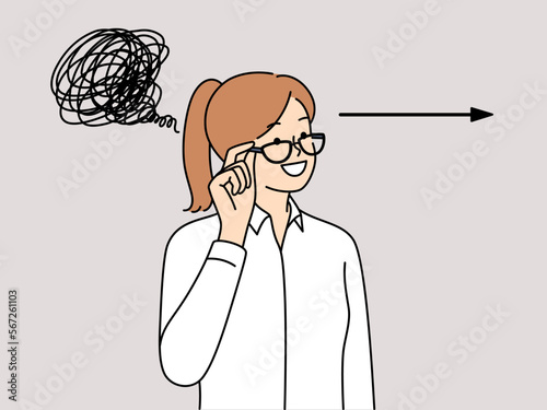 Woman smiling adjusts glasses and looks away standing near arrow and tangled long line