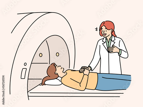Professional woman doctor prepares patient for tomography procedure in clinic