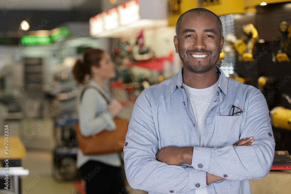 Fototapeta premium male hardware store salesman standing in store