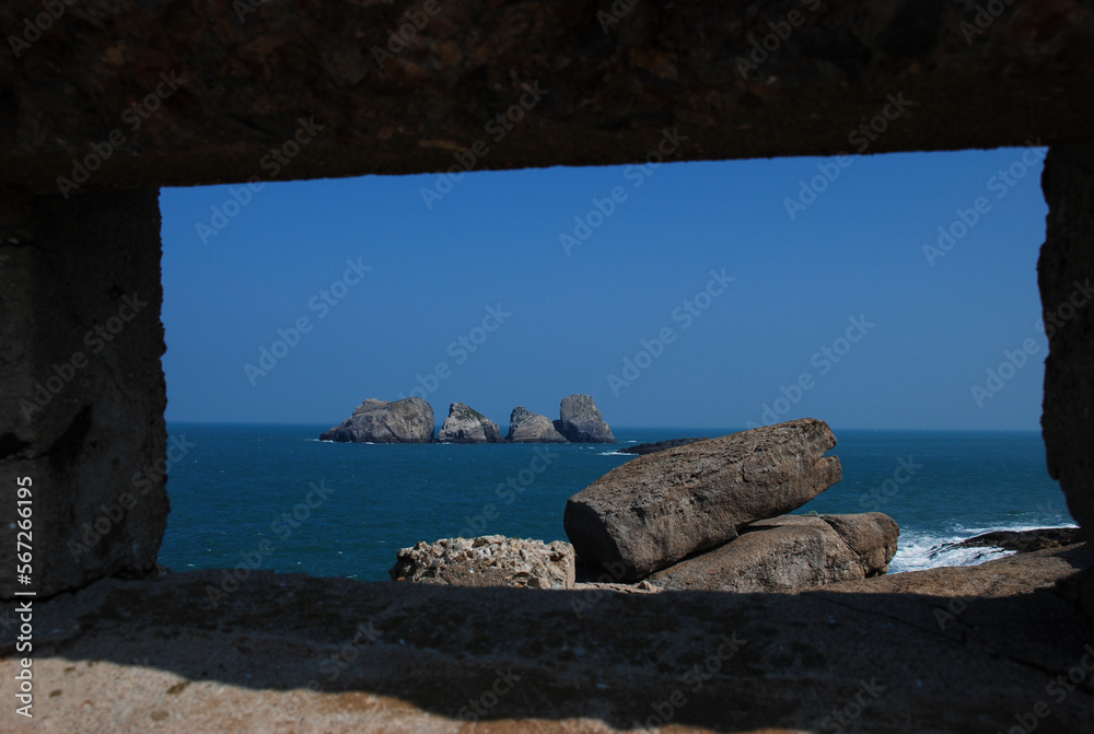 Rocks on the sea through the stone window