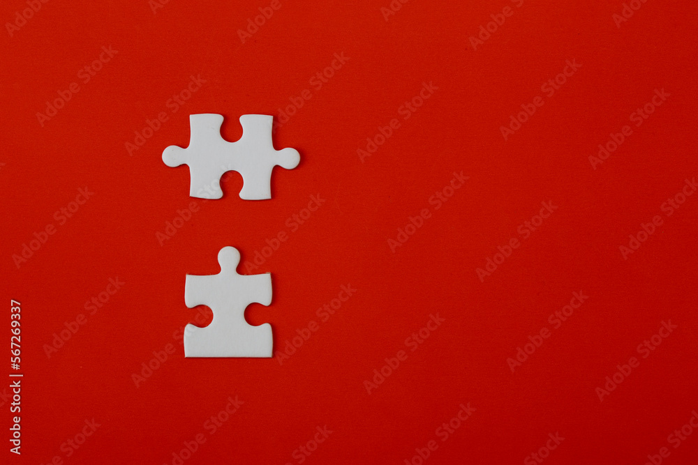 White puzzle pieces on a red background White puzzle pieces on a red background